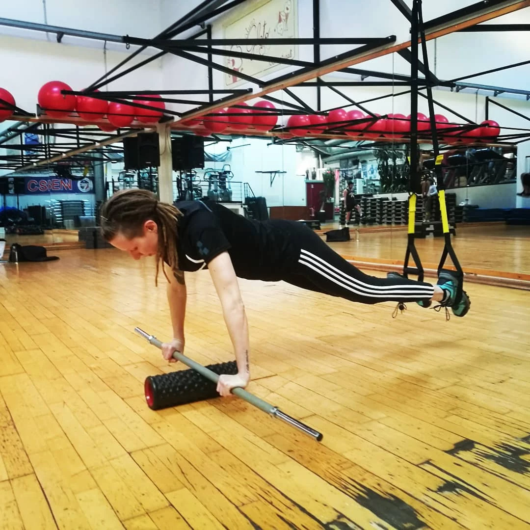 Una cliente esegue un esercizio in sospensione al TRX in palestra